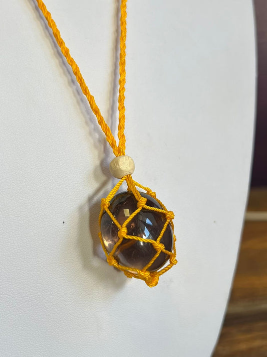 Yellow macrame crystal web holder with smokey quartz